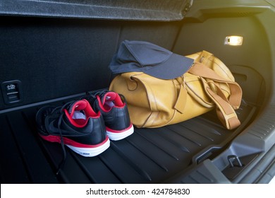 Leather Bag And Sport Shoe In Car's Trunk.