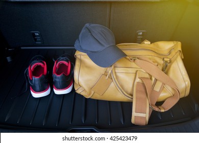 Leather Bag And Sport Shoe In Car's Trunk.