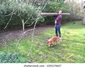 Leather Bank, Burley In Wharfedale, West Yorkshire, England, Uk 23/03/19 Young Man With Dog Carries Heavy Pole To Dump During House Clearance