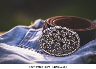 Leather belt and cool worn blue jeans.