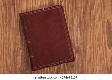 leather book on wooden board
