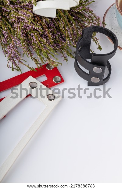 Leather bracelets on a white
background. Handmade bracelets made of genuine leather on a white
background with copy space. Small business concept. vertical
photo