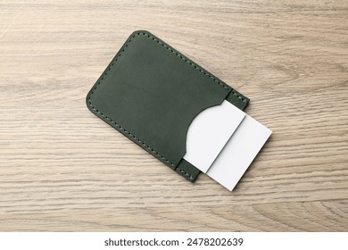 Leather business card holder with cards on wooden table, top view - Powered by Shutterstock