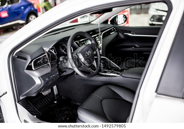 Leather car\
interior, dark upholstery. Toyota Comfortable car, interior\
cleaning. Control panel, automatic transmission, car steering\
wheel. Shymkent Kazakhstan April 15,\
2019