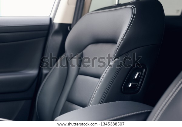 Leather\
car interior. Modern car illuminated dashboard. Luxurious car\
instrument cluster. Close up shot of automobile instrument panel.\
Modern car interior dashboard and steering\
wheel