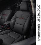 leather car seats with custom stitching and synthetic leather with red trim make the car interior look luxurious