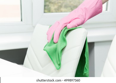 Leather Chair Back Cleaning With Cloth In The Kitchen At The Table. Upholstered Furniture. Regular Clean Up.