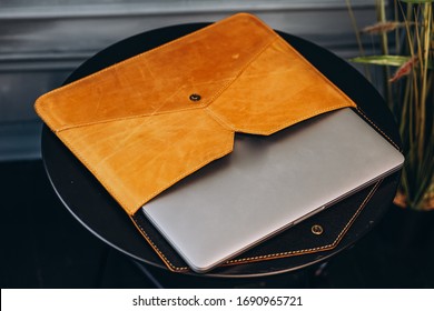 Leather cover with laptop on the table.