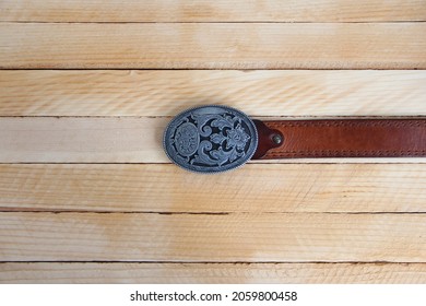 Leather cowboy belt on a wooden background