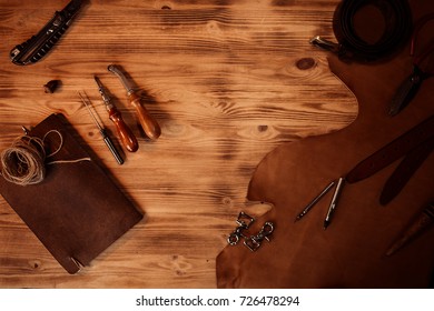 Leather craft. Tanner's tools on grey wooden background top view. Copyspace. - Powered by Shutterstock