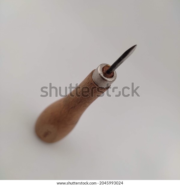 leather craft tool - diamond\
awl with sharp wooden handle for leather craft isolated on white\
background