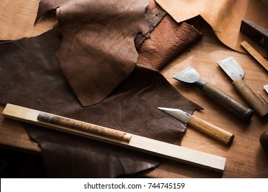 Leather Craft Or Leather Working. Large Beautifully Colored Or Tanned Leather On Leather Craftman's Work Desk . 