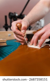 Leather crafting process showing precise cutting. Skilled artisan cuts leather with accuracy. Leather Cutting with Pattern. Leather artisan uses templates to cut hides accurately