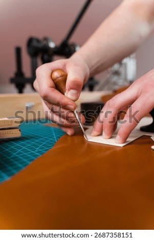 Leather crafting process showing precise cutting. Skilled artisan cuts leather with accuracy. Leather Cutting with Pattern. Leather artisan uses templates to cut hides accurately
