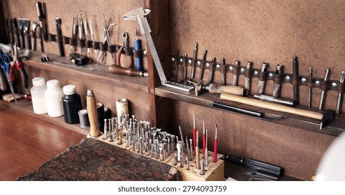 Leather crafting workshop with assorted hand tools, punches, and supplies for artisan work