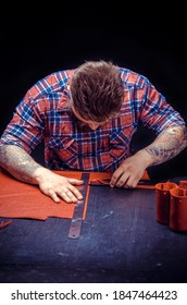 Leather Currier processing a leather workpiece at his studio