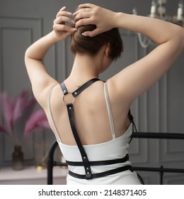 Leather detail on the model. Stylish belts on clothes. Black leather harness. Back view. Russia, Rostov-on-Don 7june2021