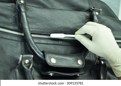 A Leather Factory Worker Cleaning A Black Leather Bag With A Cleaning Brush. The Hands Of The Worker Covered With Gloves And Cleaning The Bag With A Small Brush. 