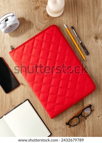 a leather folder for documents lies on the table next to the acc