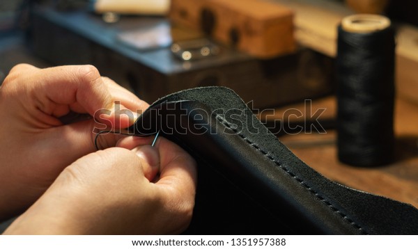 Leather handbag\
craftsman at work in a\
workshop
