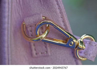 Leather Harness With A Metal Gold Carabiner On The Ring On A Pink Suede Bag