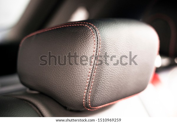 Leather interior\
of the luxury modern car. Perforated leather comfortable seats with\
stitching. Modern car interior details. Car detailing. Car inside.\
Leather texture\
background.