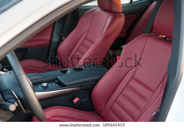 Leather interior of\
the new car. Red color.