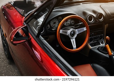 leather interior and sports steering wheel of a red convertible. car exterior - Shutterstock ID 2197296121