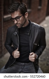 Leather jacket guy in spectacles, looking away
