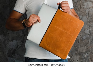 leather laptop case. Leather cover.Leather cover for laptop in the hands of a man.