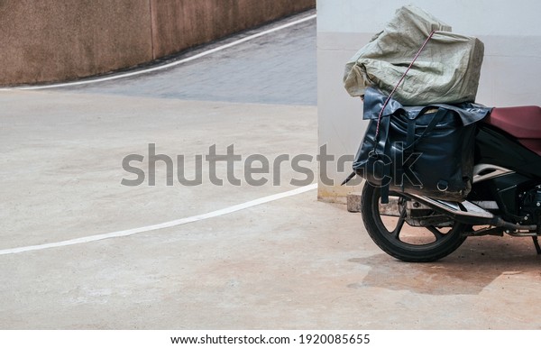 Leather luggage, rear\
luggage, motorcycle Parking on the side of the building with space\
for text input.