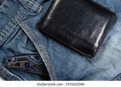 Leather men's wallet and a folding knife in the pocket.