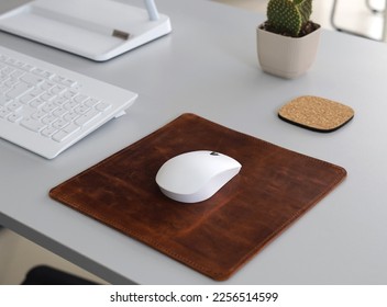 Leather Mousepad Isolated on Office Desk with White Mouse 
