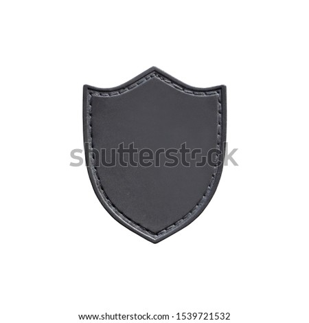 Leather patch in the form of a shield isolated on white background. Chevron