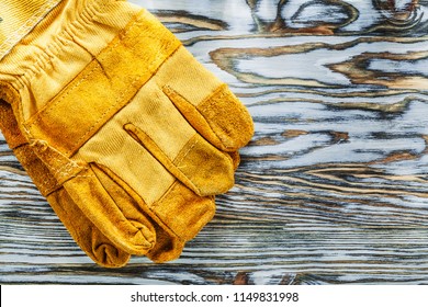 Leather Protective Gloves On Wooden Board.