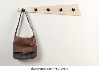 Leather Satchel Hanging On A Wooden Wall Coat Rack