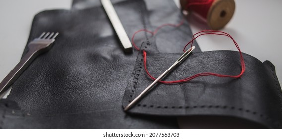 Leather. Sewing a wallet. Leather work. Tools for sewing bags, wallets, clutches. Sewing products by hand. Manufacture of leather goods. Banner