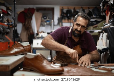 Leather shoemaker at work in a cluttered workshop crafting polished brown shoes