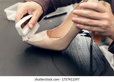 Leather shoes care concept. Shoe cleaning and polishing. Close up picture of woman hands cleaning shoes - Powered by Shutterstock