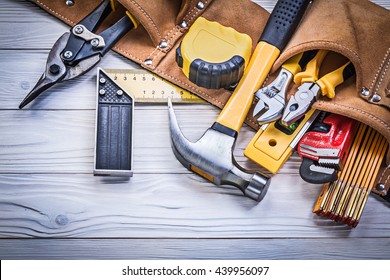 Leather tool belt with construction tooling on wooden board maintenance concept. - Shutterstock ID 439956097