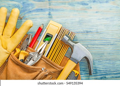 Leather Tool Belt With Construction Tooling On Wooden Board Maintenance Concept.