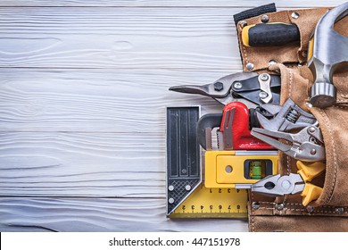 Leather Toolbelt With Building Implements On Wooden Board Copy Space Construction Concept.