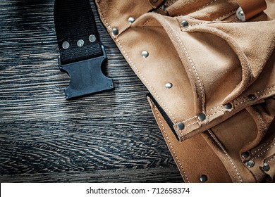 Leather Toolbelt On Black Wooden Board.