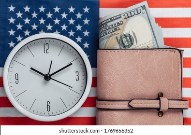 Leather Wallet With Hundred Dollar Bills, Clock On Background Of USA Flag. Time Is Money