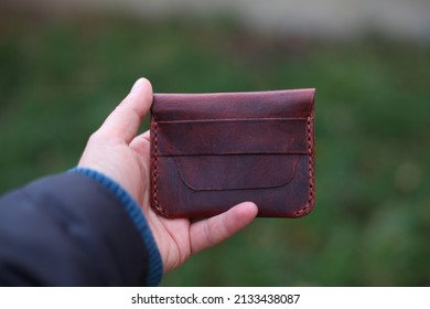 Leather wallet on the hand. Leather wallets and cardholders are very popular among men. 