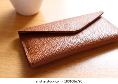 leather wallet on wood texture