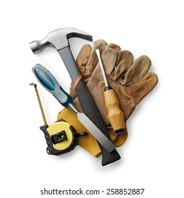 Leather working gloves with carpentry tools including a claw hammer, tape measure, chisel and screwdriver in a construction, woodworking or DIY concept