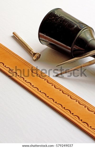 Leather\
working tools of the trade on white\
background