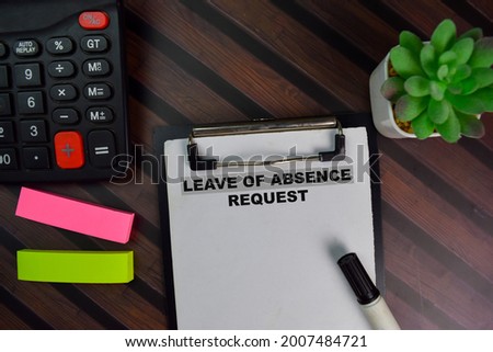 Leave of Absence Request write on a paperwork isolated on Wooden Table.