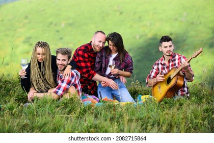 Leave All Your Worries Behind. Happy Men And Girls Friends With Guitar. Friendship. Romantic Picnic In Camp. Campfire Songs. Group Of People Spend Free Time Together. Family Camping. Hiking Adventure